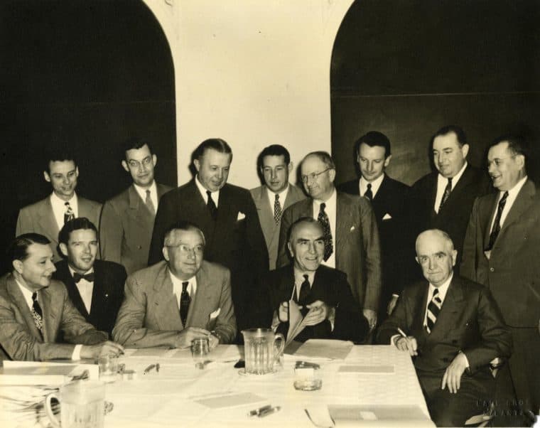 A historic investment committee gathered around a table